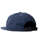 Navy blue cap with a black strap on a light gray background