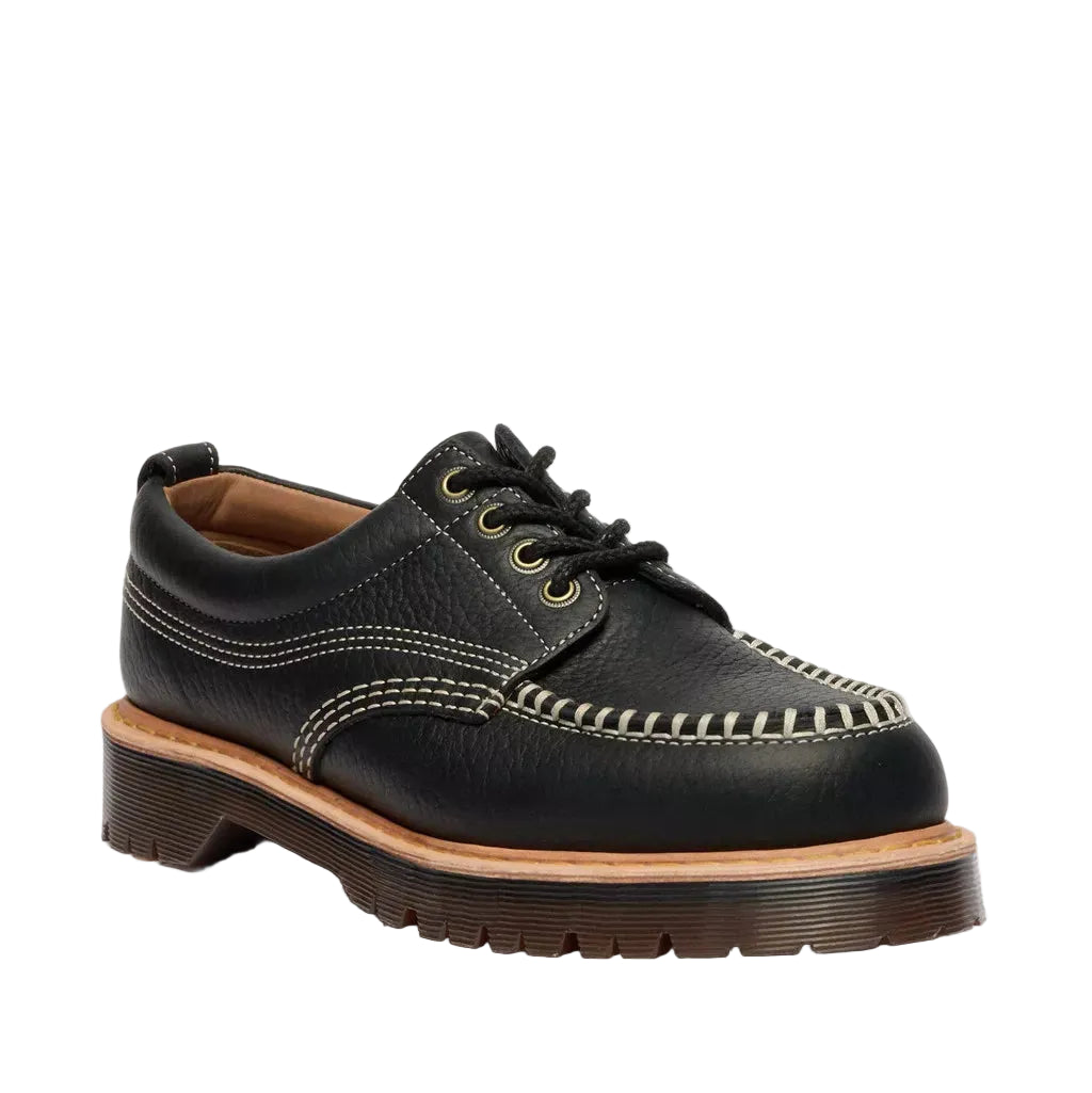 Black leather shoe with brown sole on a white background