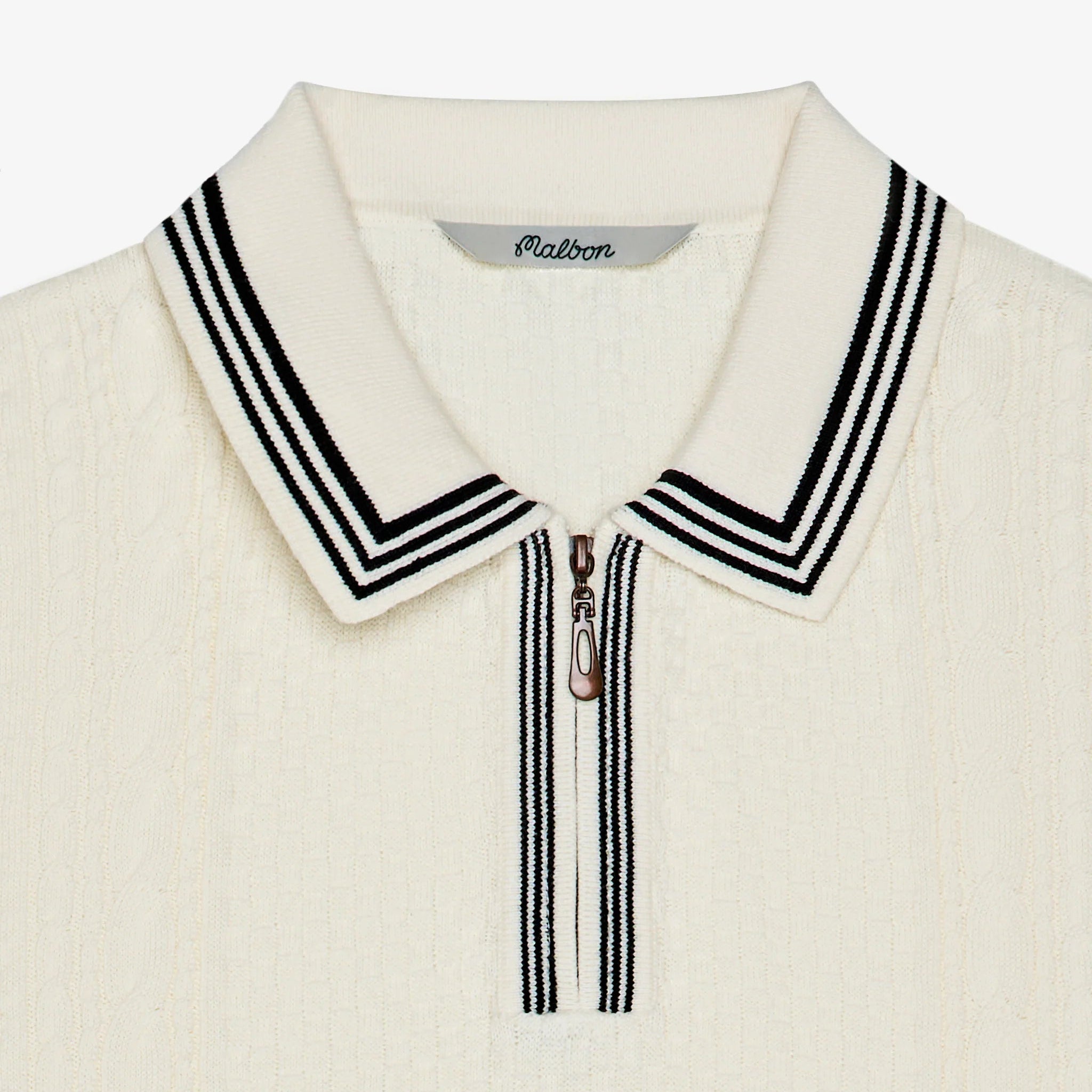 Close-up of a cream-colored sweater with a striped collar on a white background