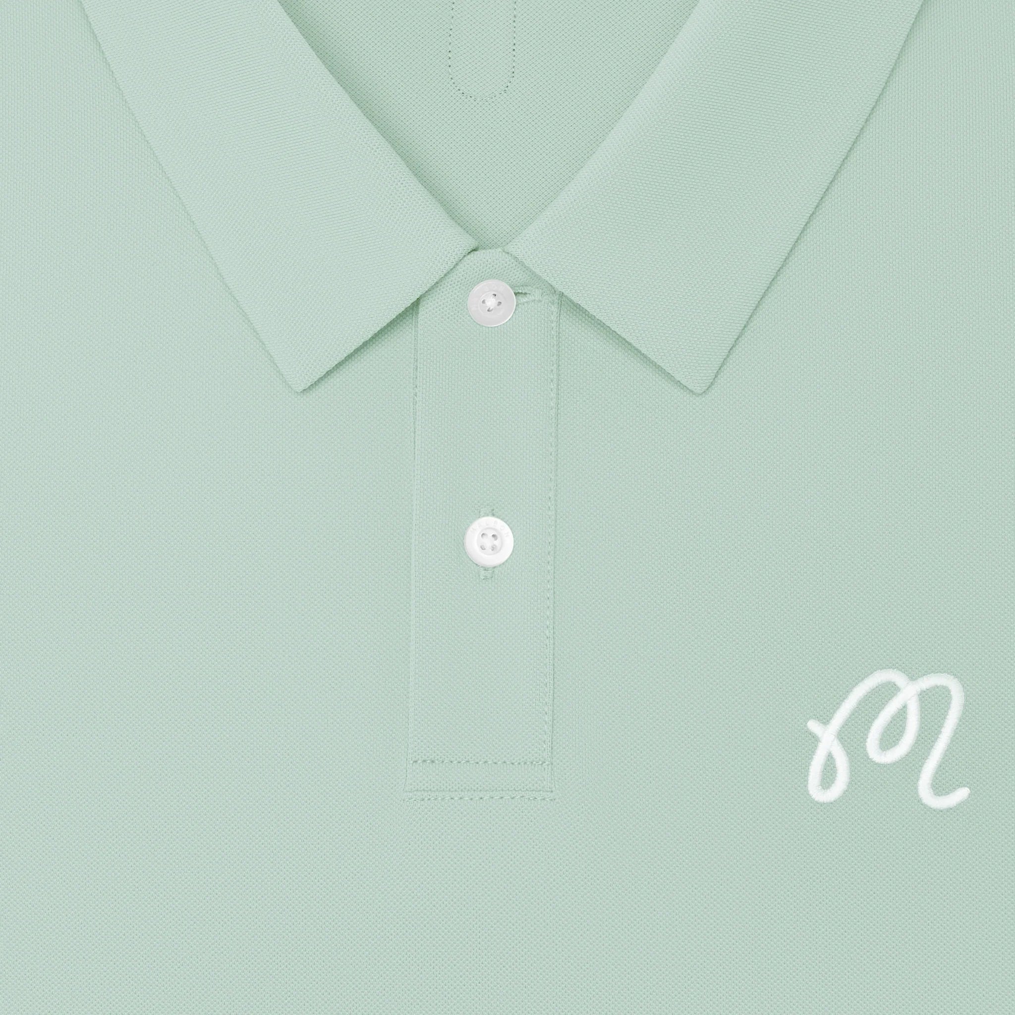 Light green shirt collar with buttons and a brand logo on a light green background