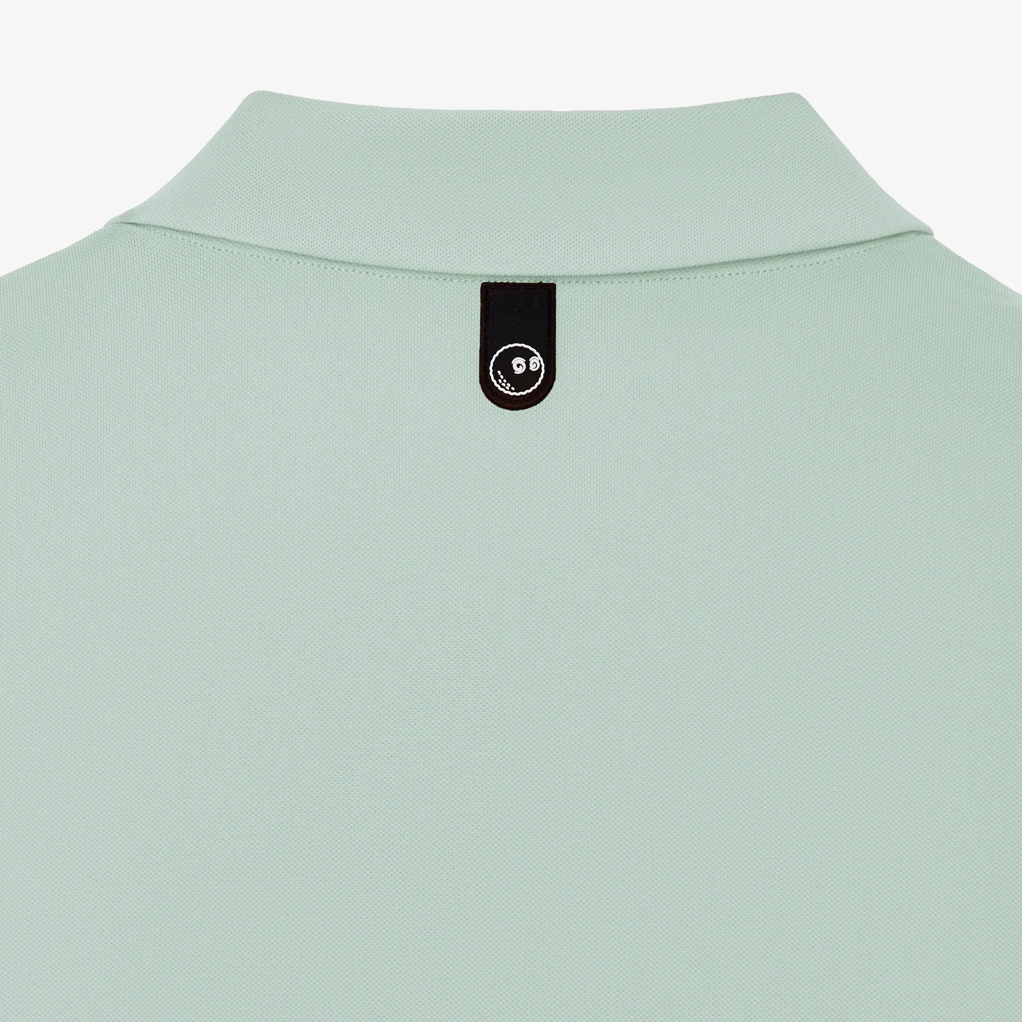 Light green shirt collar with a brand tag on a white background