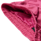 Close-up of pink waistbandwith a brand logo on a white background