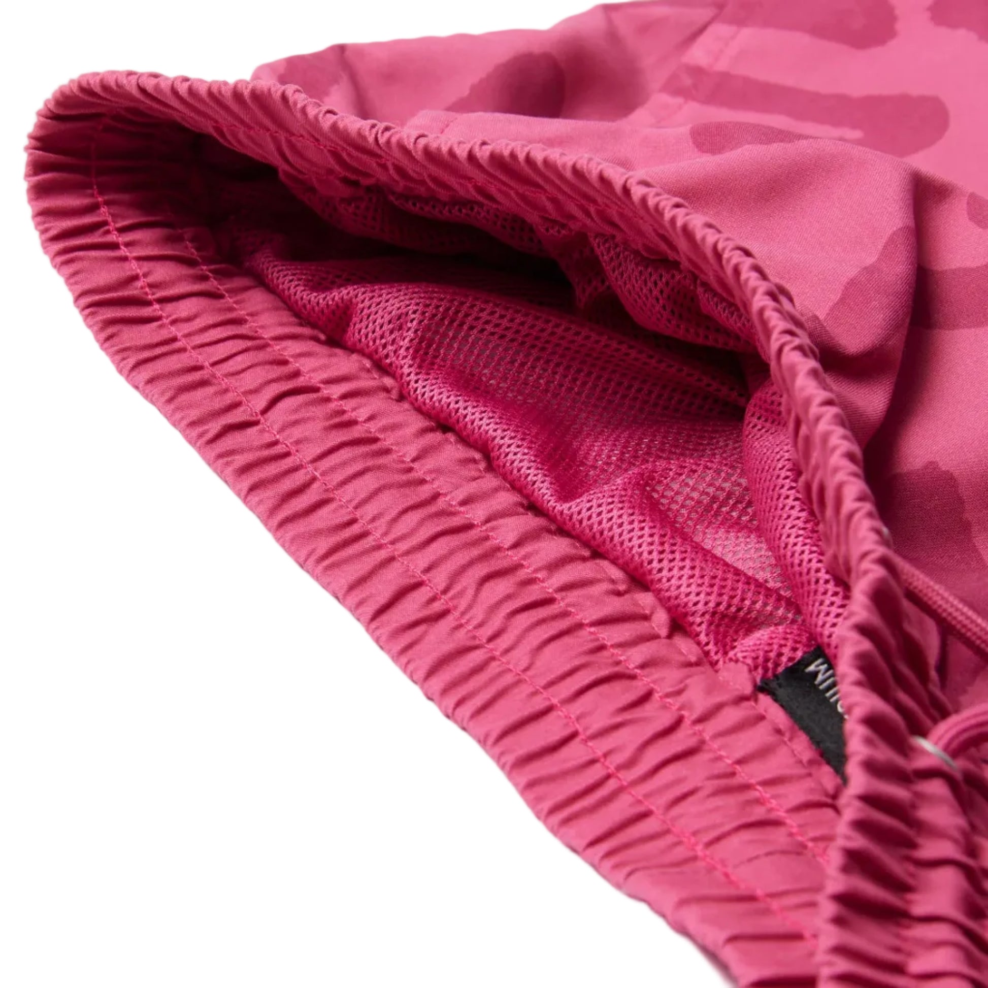 Close-up of pink waistbandwith a brand logo on a white background