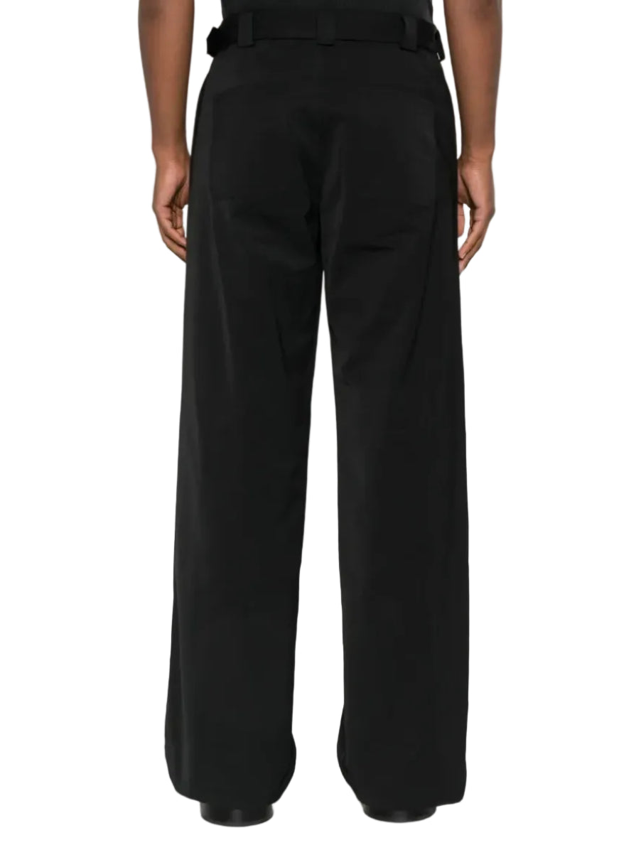 Black wide-leg pants worn by a person on a white background