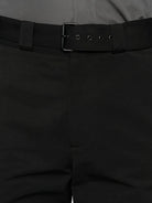 Close-up of black pants with a belt buckle.