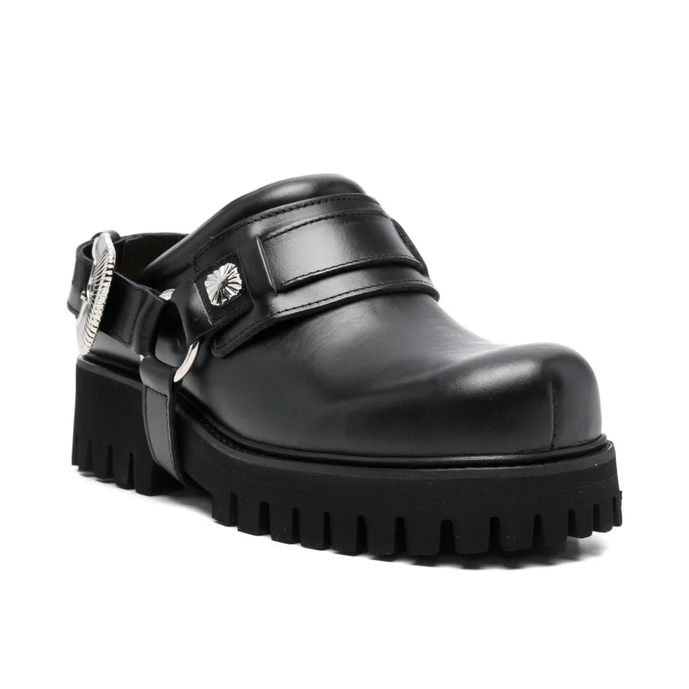 Black leather mule shoe with chunky sole on a white background