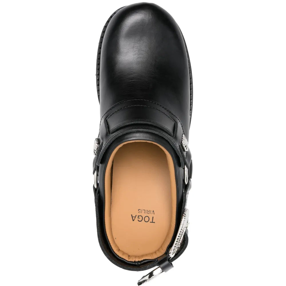 Black leather mule with a tan insole on a white background