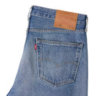 Close-up of a Levi's denim pocket with brand label on a white background