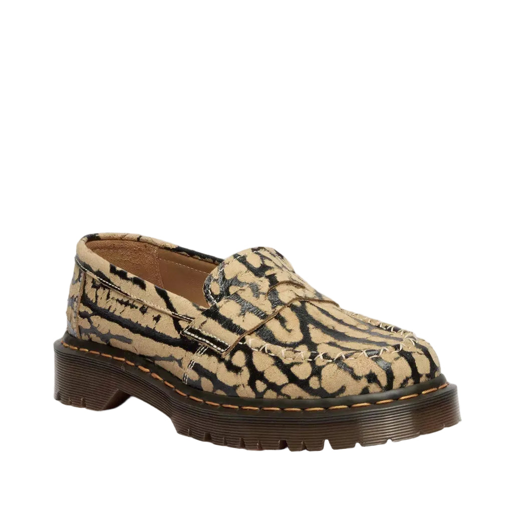 Loafer shoe with patterned upper and brown sole on a white background