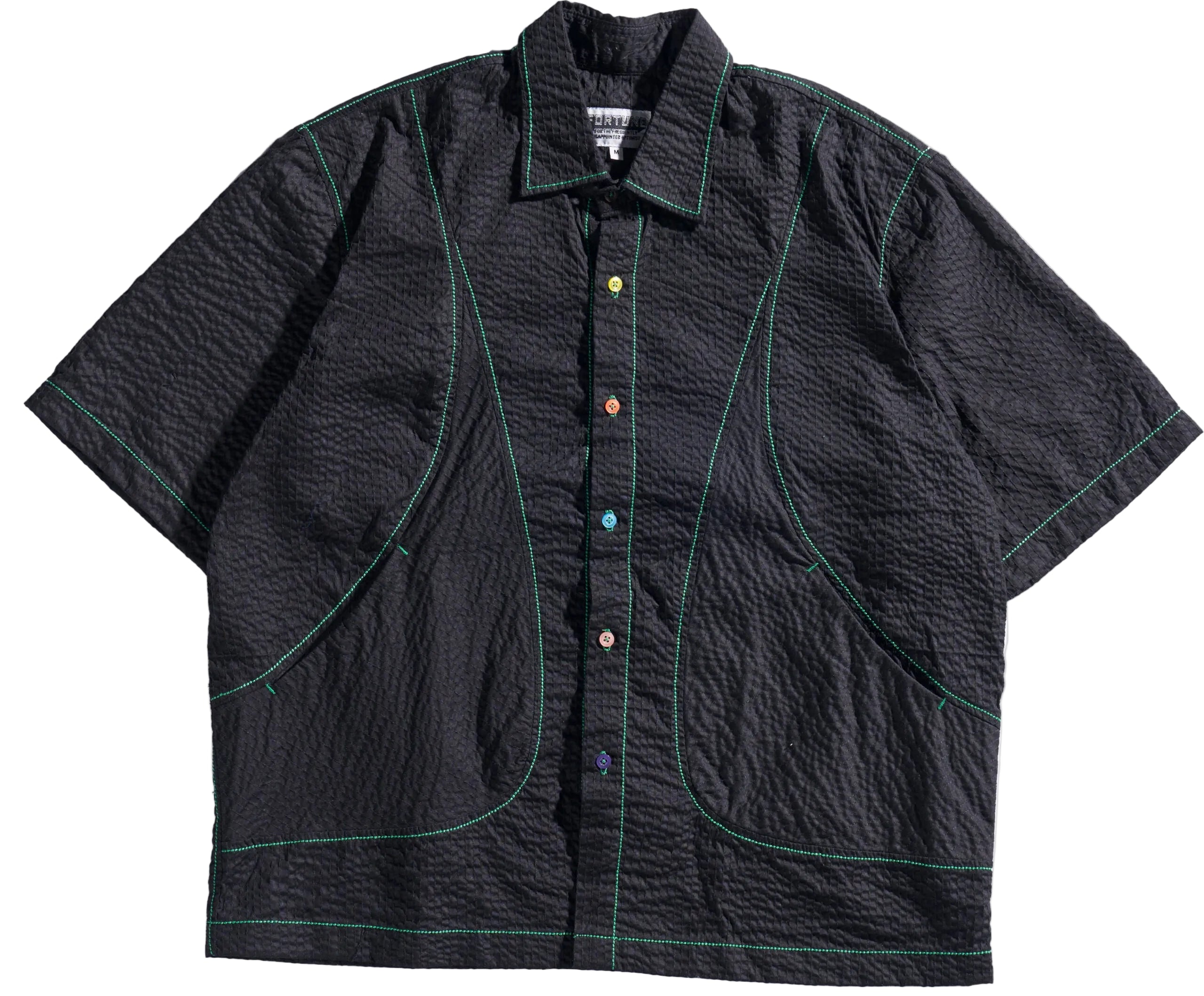 Black textured shirt with green stitching on a white background