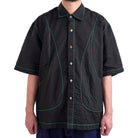 Black textured shirt with colorful buttons on a white background
