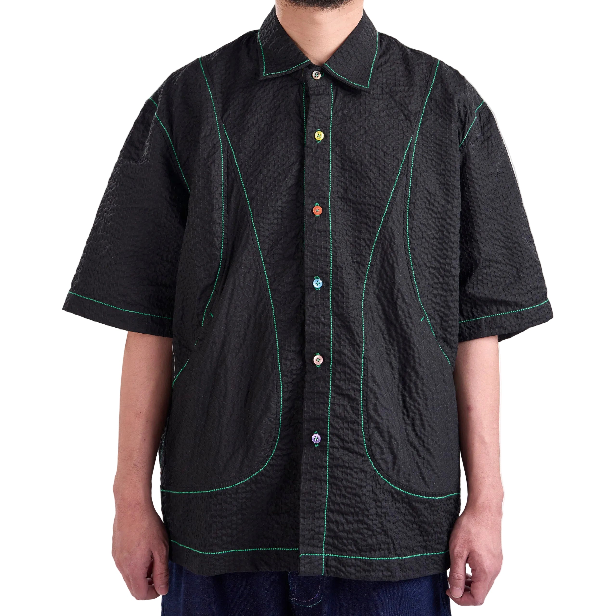 Black textured shirt with colorful buttons on a white background