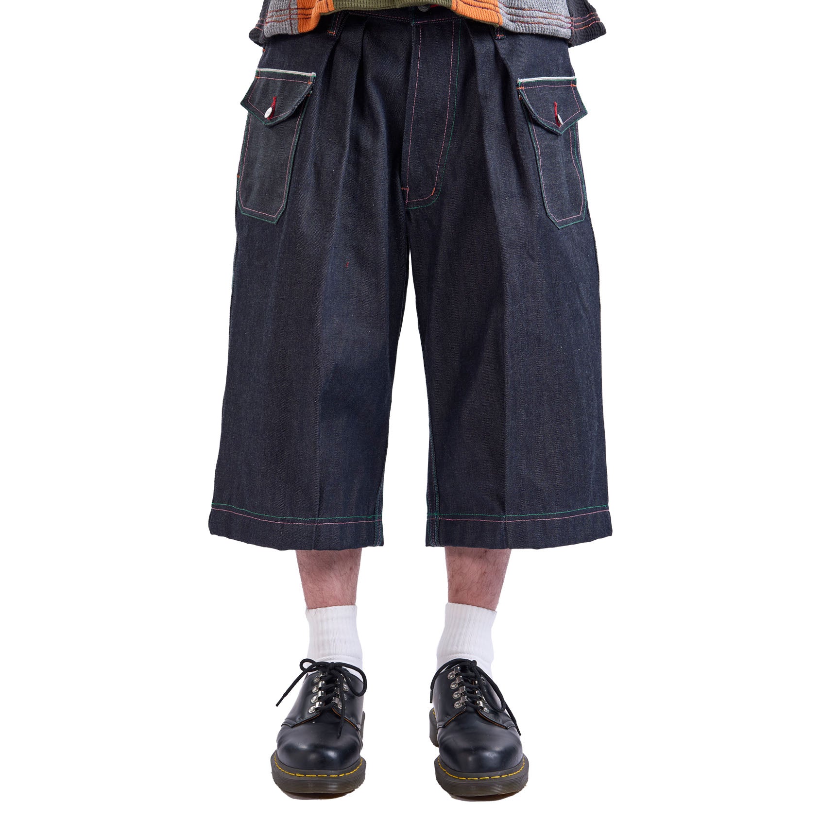 Dark blue denim capri pants worn by a person on a white background