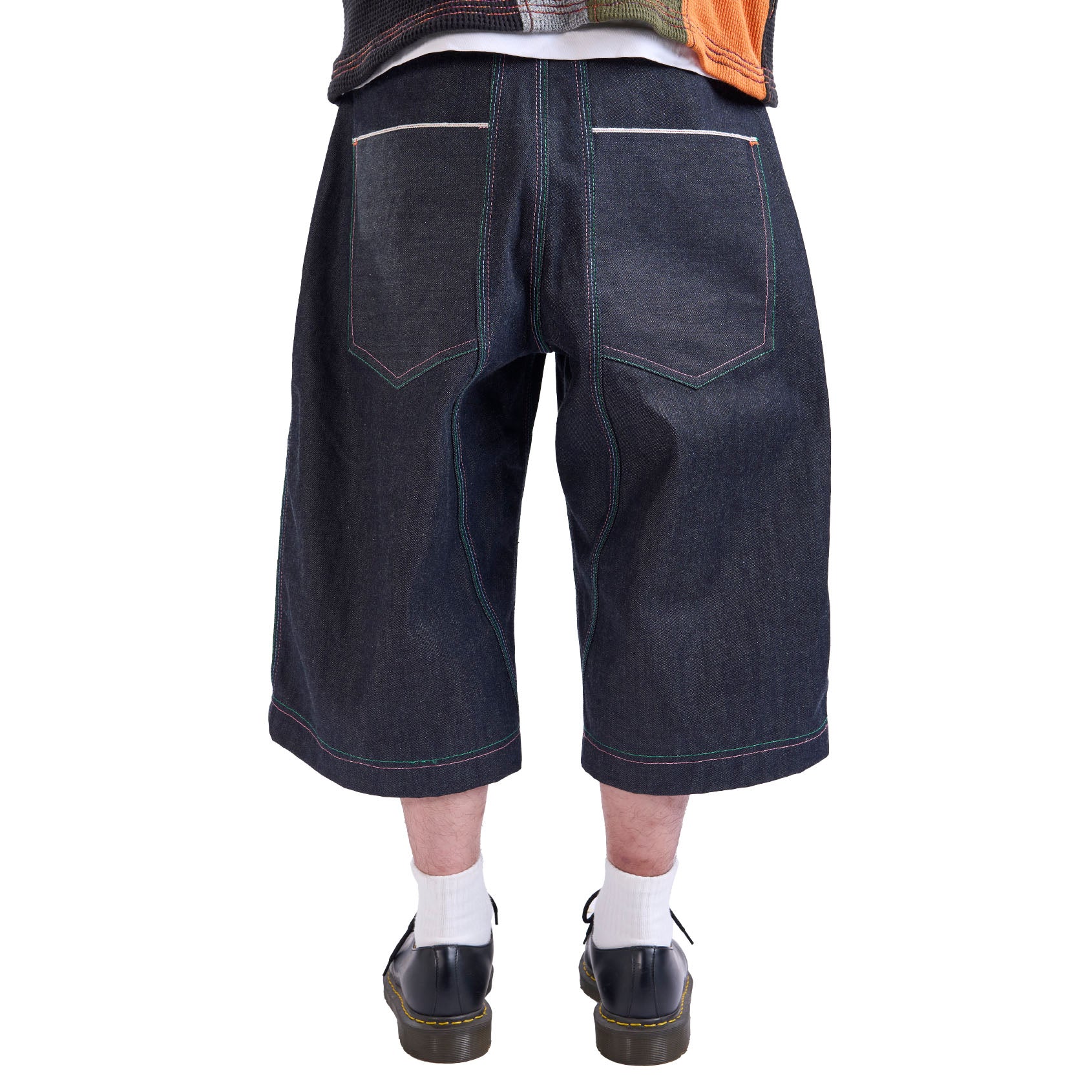 Denim shorts worn by a person on a white background