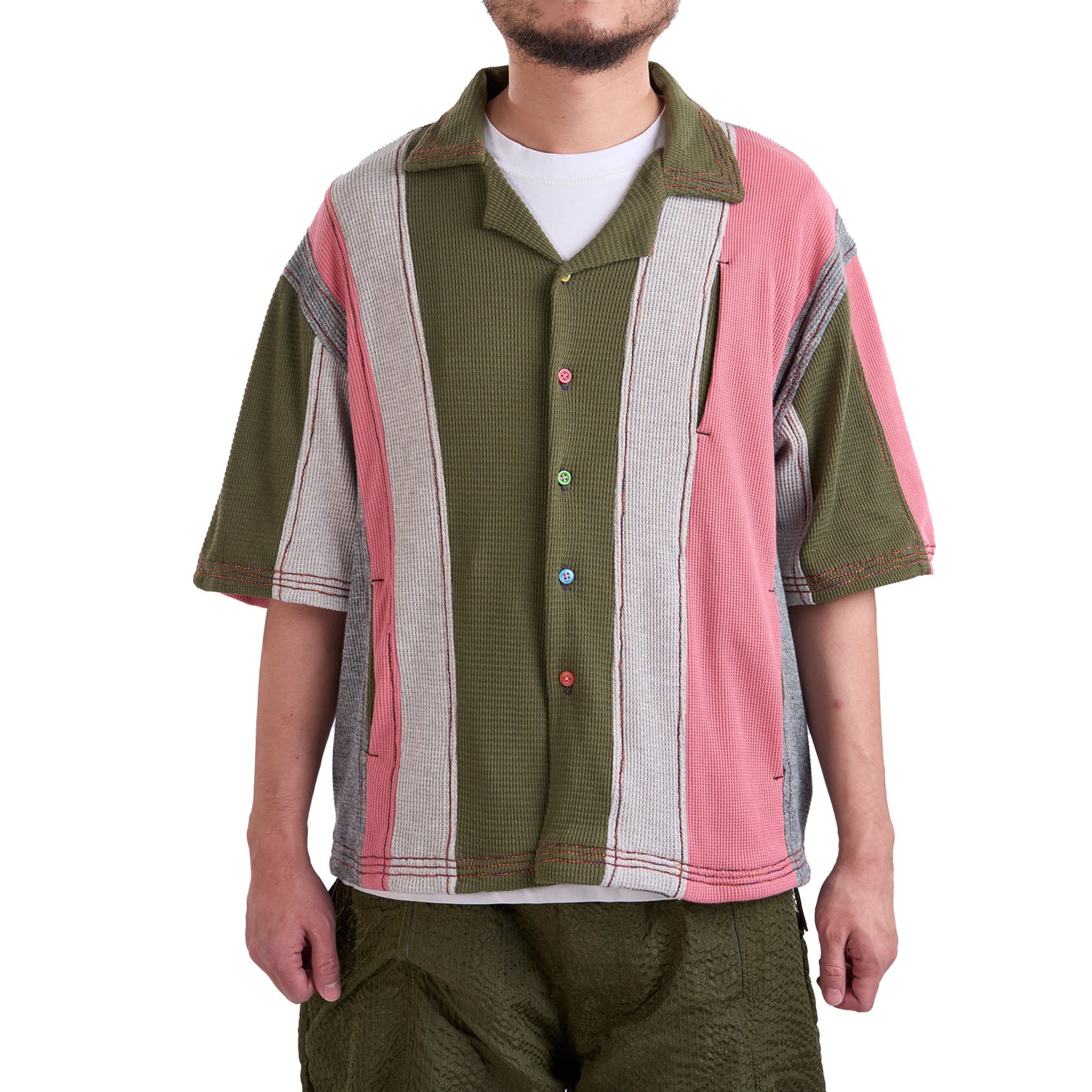 Person wearing a colorful patterned shirt with a white background
