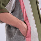 Close-up of a person wearing a colorful patterned shirt with a white background