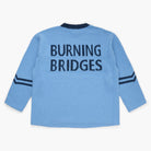 Blue sweater with 'Burning Bridges' knit on the back on a white background