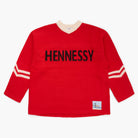 Red sweater with 'Hennessy' knit at the front on a white background
