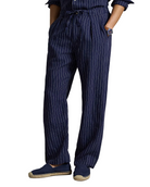 Person wearing navy pinstripe pants with a plain background