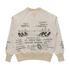 A beige crewneck sweatshirt with a black graphic print of a rowing team and text listing names and 'St. Denis Port Training Academy' on the back.
