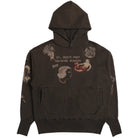 A dark brown pullover hoodie featuring vintage-style graphic prints on the front and sleeves, including a mermaid, a profile portrait, and the text 'ST. DENIS PORT TRAINING ACADEMY 502'.