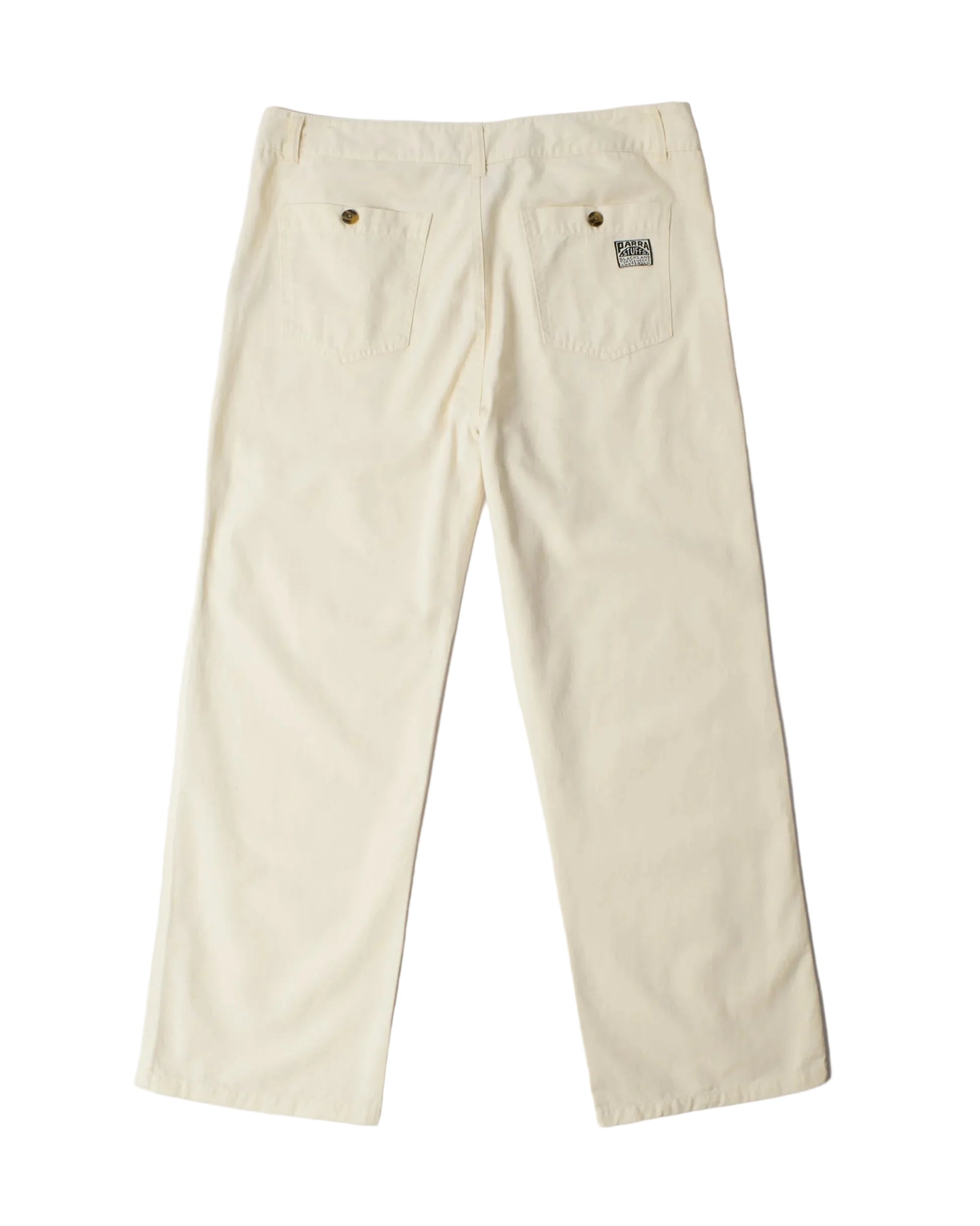 A pair of off-white canvas work pants shown from the back, featuring two back pockets with metal rivets and a small woven brand patch on the right pocket.