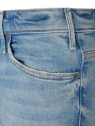 Close-up of blue denim jeans with a focus on the stitching and fabric texture.