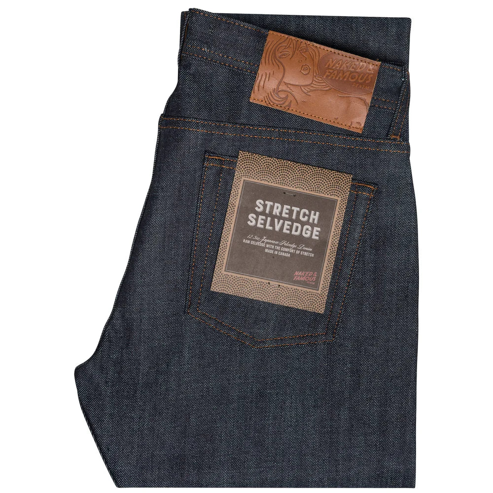 Folded dark blue jeans on a white background