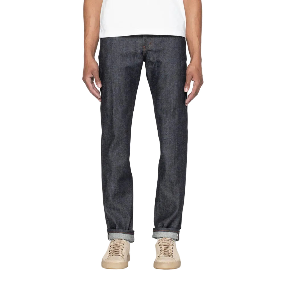 Person wearing dark blue jeans on a white background