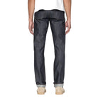Person wearing dark blue jeans on a white background