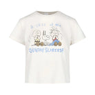 An off-white short-sleeve t-shirt featuring a Peanuts graphic of Charlie Brown, Snoopy, and Woodstock with the text 'a case of the SUNDAY SCARIES!' printed in blue and brown.