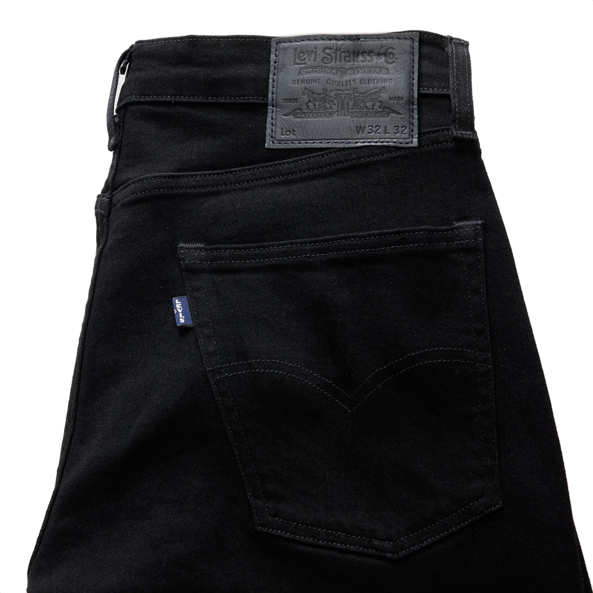 Close-up of the back pocket on black Levi’s 511 Slim Jeans, with a dark leather-look patch, a blue Levi’s tab, and tonal arcuate stitching.