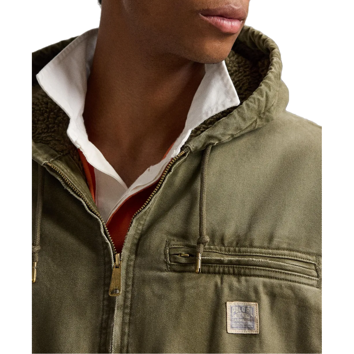 Close-up of a person wearing an olive green hooded jacket with a white collared shirt underneath, shown against a plain white background.