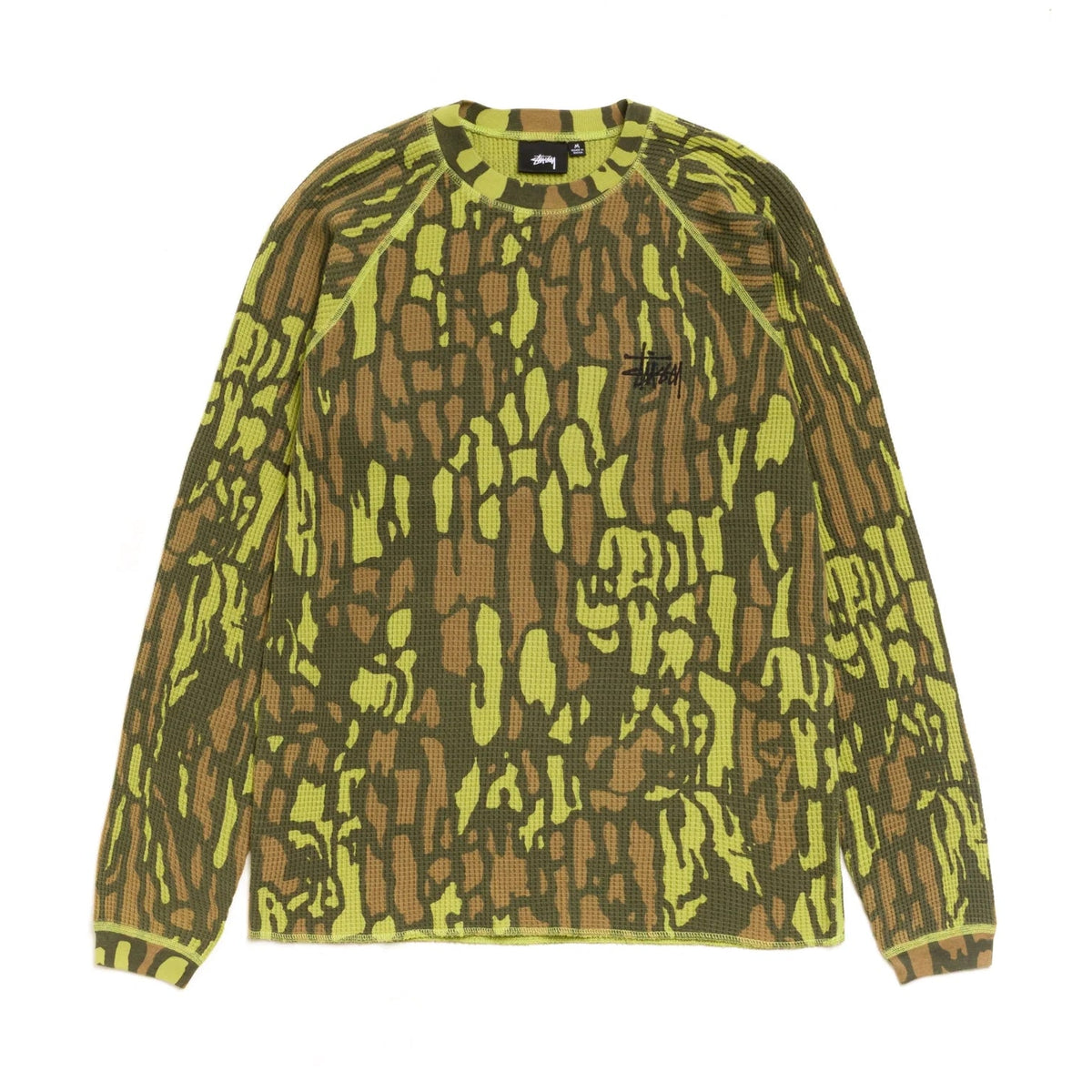 Front view of the Stüssy Basic Stüssy Thermal in tree bark camo laid flat. A long-sleeve waffle-knit top in a lime, olive and brown camo print, with raglan sleeves, lime contrast stitching and a small black Stüssy logo on the chest.
