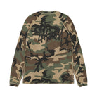 Back view of the woodland camo thermal laid flat, showing a large black Stüssy logo across the upper back.