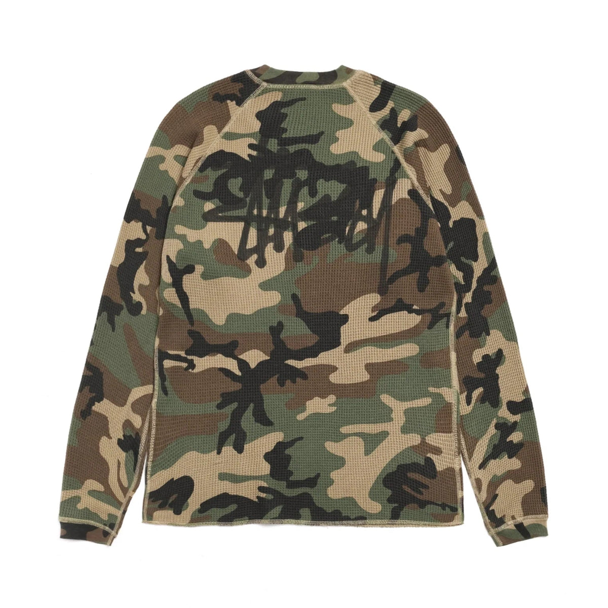 Back view of the woodland camo thermal laid flat, showing a large black Stüssy logo across the upper back.