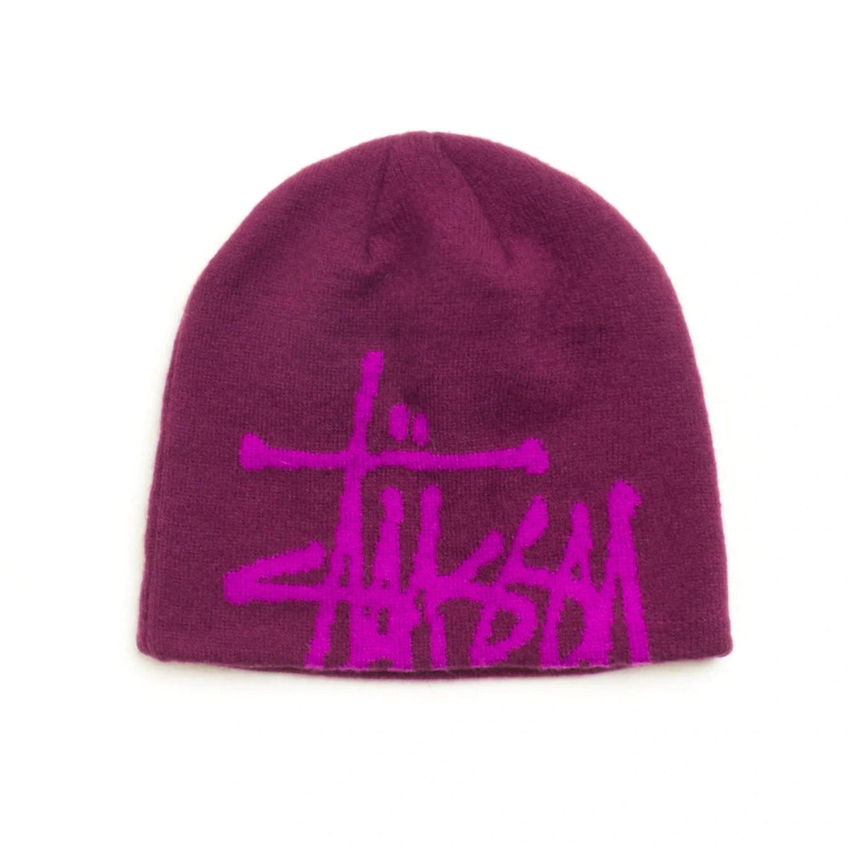 A dark magenta knit beanie featuring a bright pink Stüssy logo embroidered on the front, set against a plain white background.