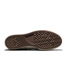 Bottom view of a Converse Chuck 70 sole, showing the brown rubber diamond-tread pattern and the Converse star logo.
