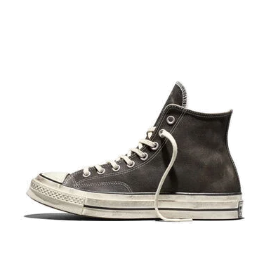 side view of a black Converse Chuck 70 Hi Burnished Leather sneaker on white, with a worn rubber toe cap and the All Star license plate on the heel.