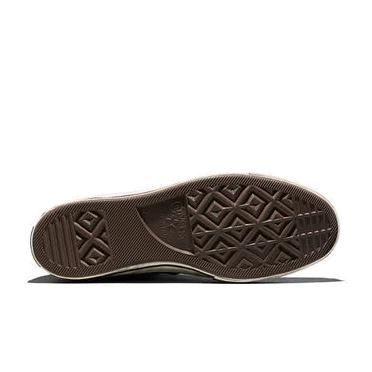 Bottom view of a Converse Chuck 70 sole, showing the brown rubber diamond-tread pattern and the Converse star logo.