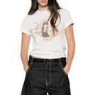 A model wearing a white graphic t-shirt and black wide-leg denim jeans, standing against a plain white background.