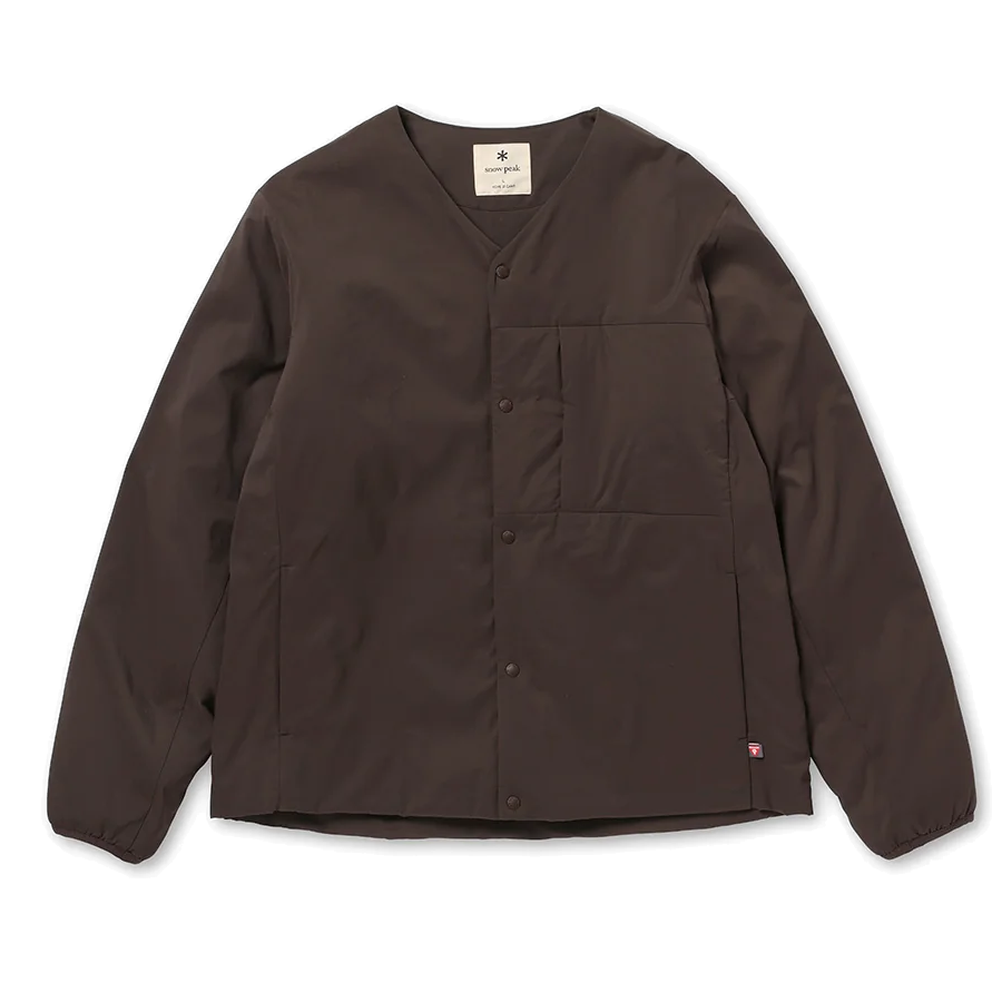 Front view of a dark brown Snow Peak Flexible Insulated Cardigan laid flat on white, showing the collarless V-neck, snap-button front, chest pocket and elastic cuffs.