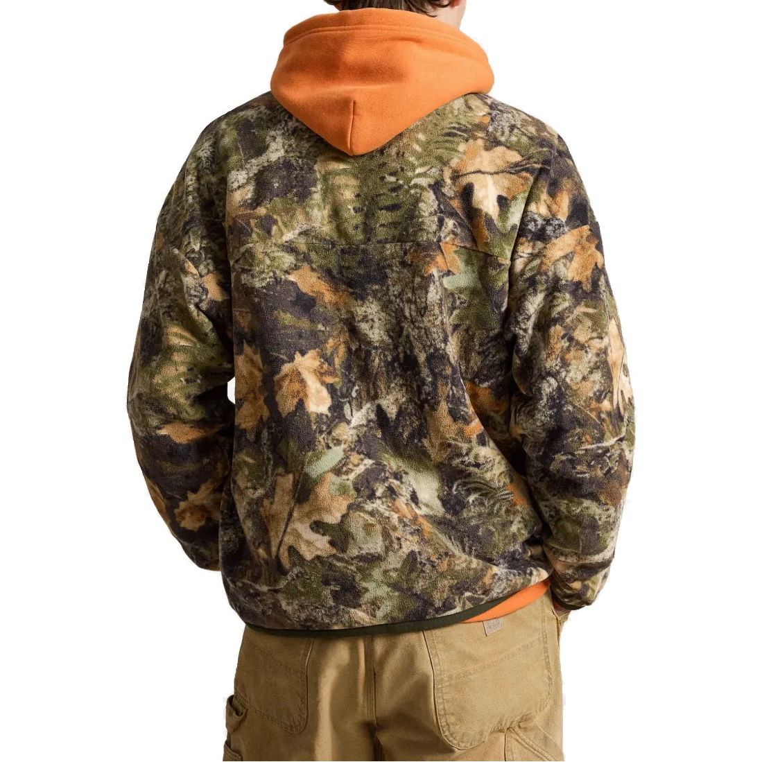 A man viewed from behind wearing a camouflage hooded jacket with a bright orange hood, a beige knit beanie, and khaki pants, set against a plain white background.