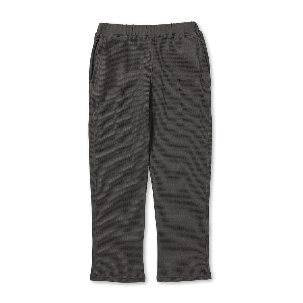 Front view of charcoal Snow Peak Heavyweight Waffle Pants laid flat on white, showing the elastic waistband, side pockets, straight legs and waffle-knit texture.