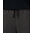 Close-up of the waistband on charcoal Snow Peak Heavyweight Waffle Pants, showing the ribbed elastic waist, black drawstring with metal tips and waffle-knit texture.