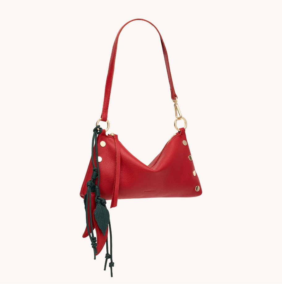 Red handbag with decorative elements on a white background