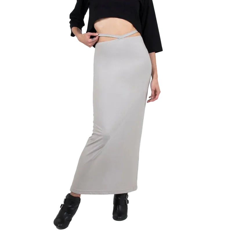 Person wearing a black top and light gray skirt on a white background