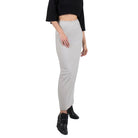 Person wearing a black top and light gray skirt on a white background