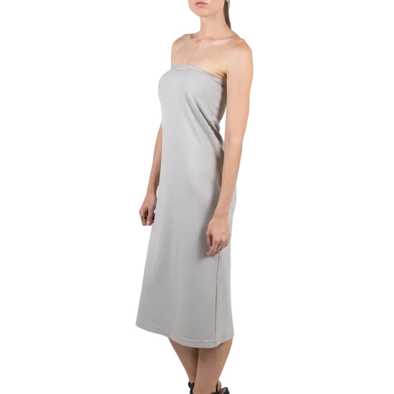 Woman wearing a strapless gray dress on a white background