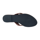 A top-down view of a flat flip-flop sandal showing a dark navy blue sole and a brown leather strap, isolated on a white background.